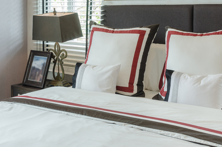 classic lamp style with wooden picture frame on table side in luxury bedroomの写真素材