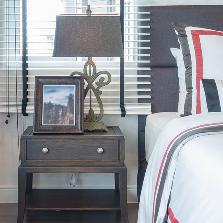 classic lamp style with wooden picture frame on table side in luxury bedroomの写真素材