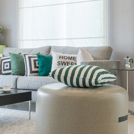 green and white pillows on round chair in modern living roomの写真素材