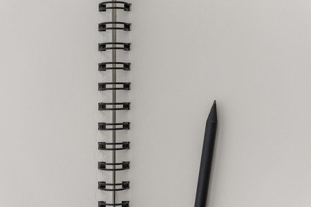 black pencil on blank notebookの写真素材