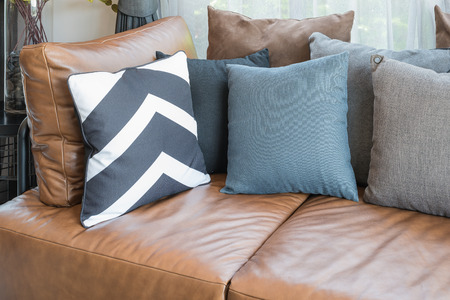 pillows on brown leather sofa in modern living roomの写真素材