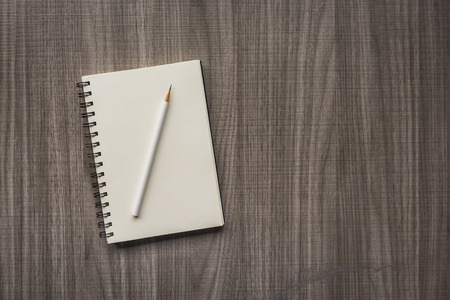 white pencil with blank notebookの写真素材