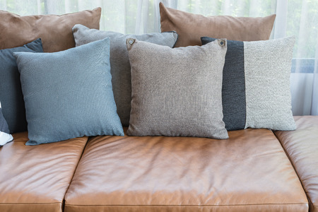pillows on brown leather sofa in modern living roomの写真素材