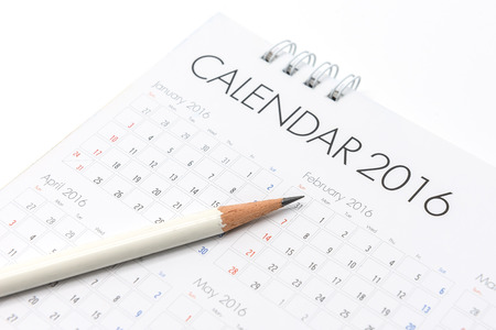 White paper desk spiral calendar 2016 on white background with white pencil