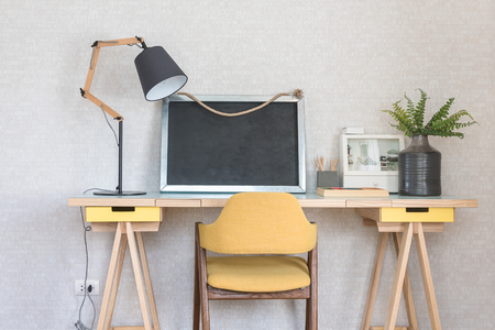 wooden working table with yellow chair in kid's room designの写真素材