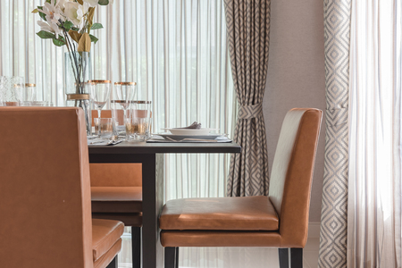modern dinning room  with wooden table and orange chairの写真素材