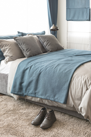modern bedroom with brown shoes on carpetの写真素材