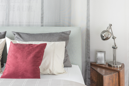 black lamp  in modern bedroom design with red pillows on bedの写真素材