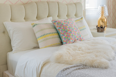 colorful pillows on white bed in modern bedroom style