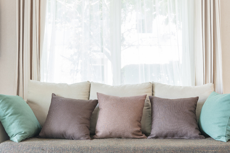 modern sofa and set of pillows in modern bedroom designの写真素材