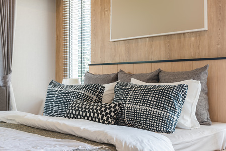 black and white pillows on bed in modern bedroom design