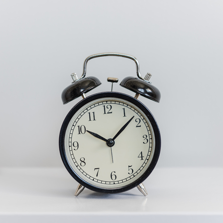 modern black alarm clock on white backgroundの写真素材