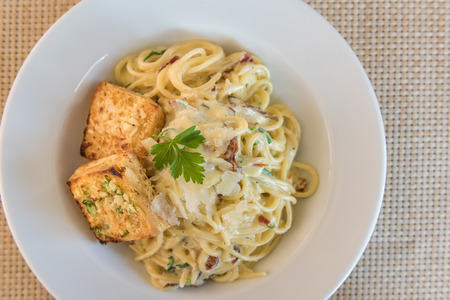 Spaghetti Carbonara with bacon and cheese in restuarantの写真素材