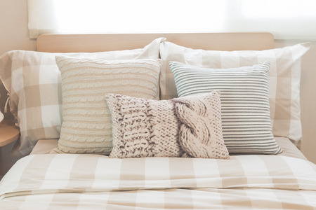 set of pillows on modern bed in modern bedroom designの写真素材