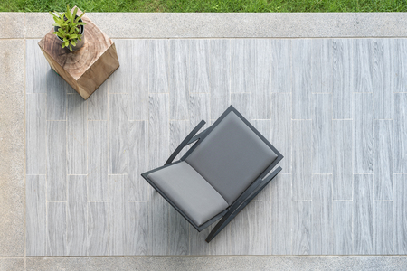 modern grey leather chair with vase of plant on terrace, top viewの写真素材