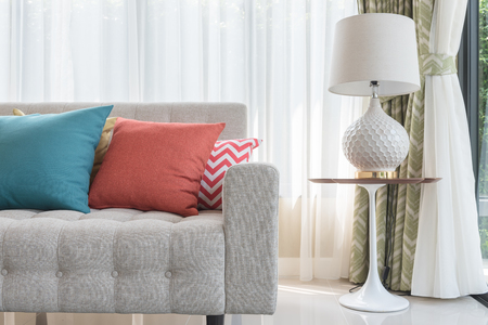colorful pillows on classic sofa style in living room with white lampの写真素材