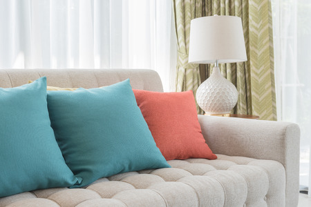 colorful pillows on classic sofa style in living room with white lampの写真素材