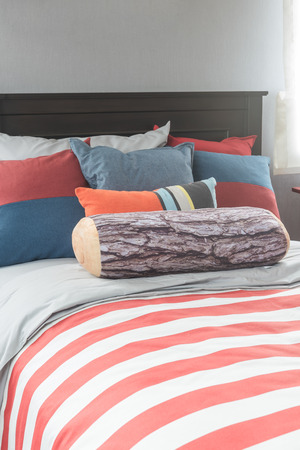 colorful pillows on bed in single bedroom designの写真素材