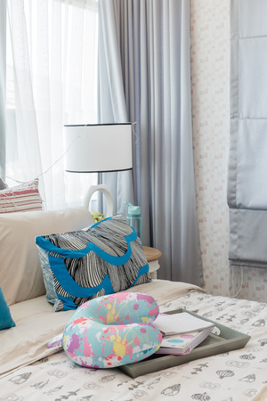 colorful pillows on bed in luxury girl's bedroom designの写真素材