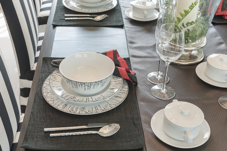 table set on wooden table in luxury dining room designの写真素材