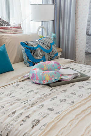 colorful pillows on bed in luxury girl's bedroom designの写真素材