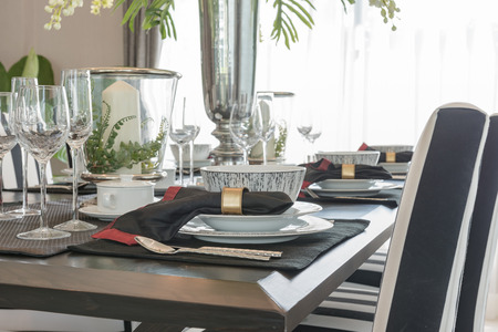 table set on wooden table in luxury dining room designの写真素材