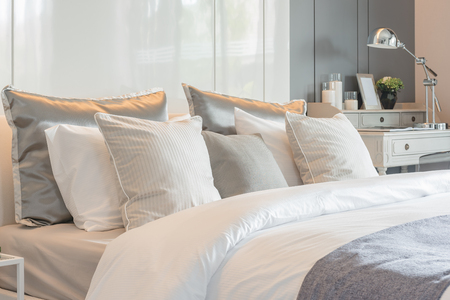 pillows set on bed with vase of flower in luxury bedroom designの写真素材