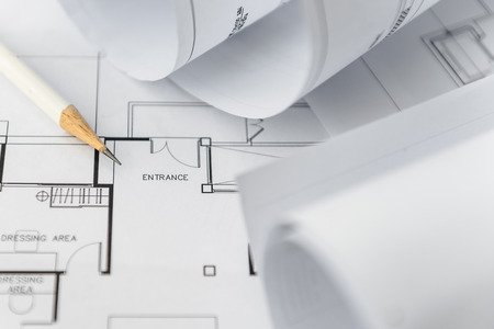 white pencil on architectural for construction drawings  with roll of blueprintの写真素材