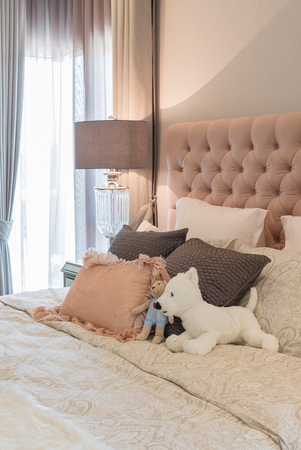 luxury bedroom design with classic lamp on table side and dollsの写真素材