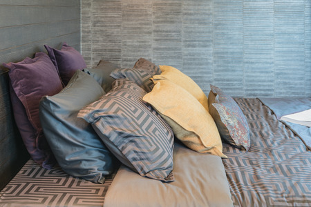 set of pillows on bed in modern bedroom design