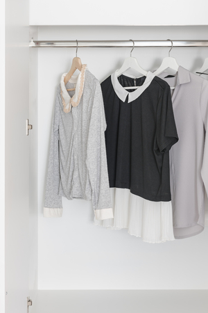 black and white color tone clothes in modern white wardrobeの写真素材
