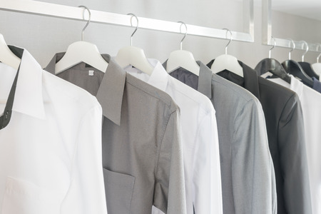 black and white color tone clothes in modern white wardrobeの写真素材