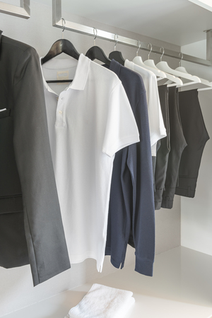 black and white color tone clothes in modern white wardrobeの写真素材