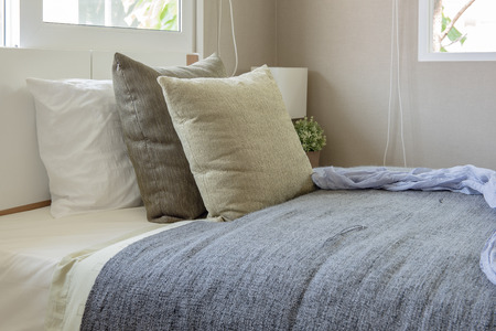 white modern bed with pillows in modern single bedroom designの写真素材
