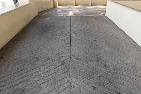 Empty parking deck with ramp in parking buildingの写真素材