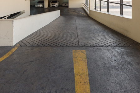 Empty parking deck with ramp in parking buildingの写真素材