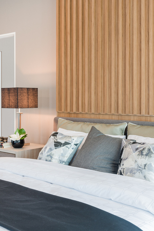 modern bedroom design with decorated wooden panel on wallの写真素材