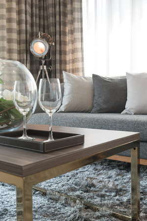 row of pillows on grey sofa with black lamp in living room designの写真素材