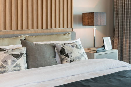 modern bedroom design with decorated wooden panel on wallの写真素材