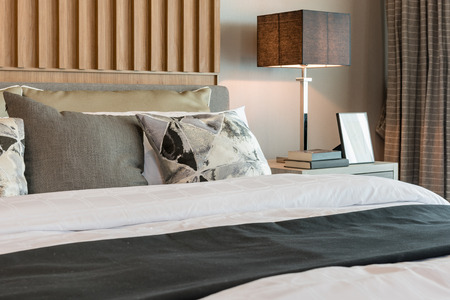 modern bedroom design with decorated wooden panel on wallの写真素材