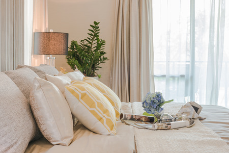 vase of flower on classic bed style in bedroom design