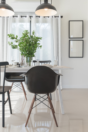 modern dinning room with black modern chair and vase of plant on tableの写真素材