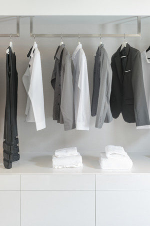 black and white color tone clothes in modern white wardrobeの写真素材