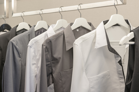 black and white color tone clothes in modern white wardrobeの写真素材