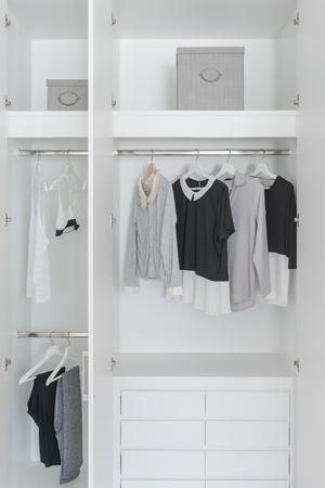 black and white color tone clothes in modern white wardrobeの写真素材