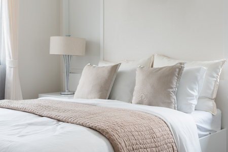 modern lamp on table side with picture frame on wall in bedroom designの写真素材