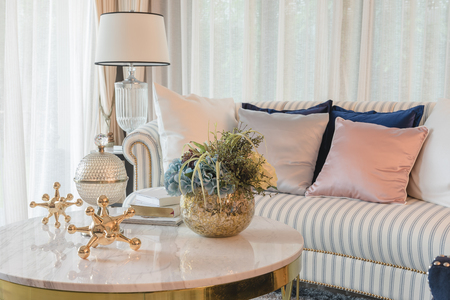 set of sofa with pillows and classic white lamp in luxury living room, interior designの写真素材