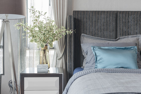 modern bedroom with black color bed tone and set of pillows, interior design