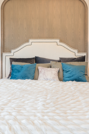 luxury bedroom with blue pillows on bed, interior designの写真素材
