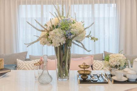 luxury table set on dinnig table with vase of flower in dining room interior designの写真素材